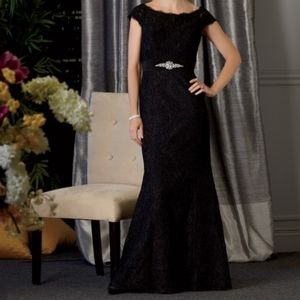 Lace trumpet style gown with off shoulder neckline tapering to a V-back.